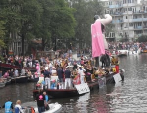 people with giant statue on boat thumbnail