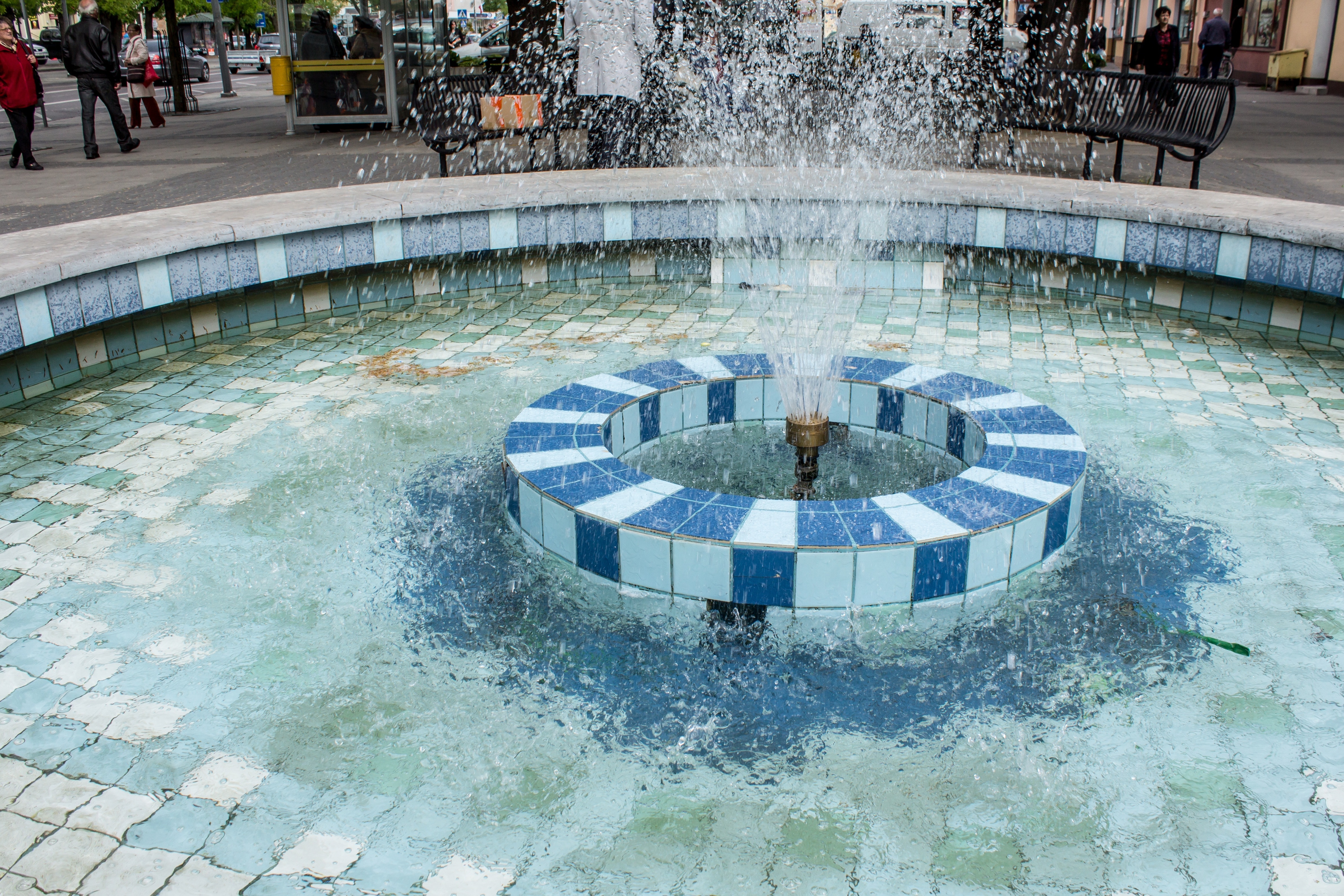blue and white ceramic tiles framed outdoor fountain