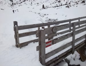 snow on brown wooden fence thumbnail
