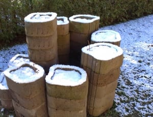 brown cylindrical containers on snowy field thumbnail