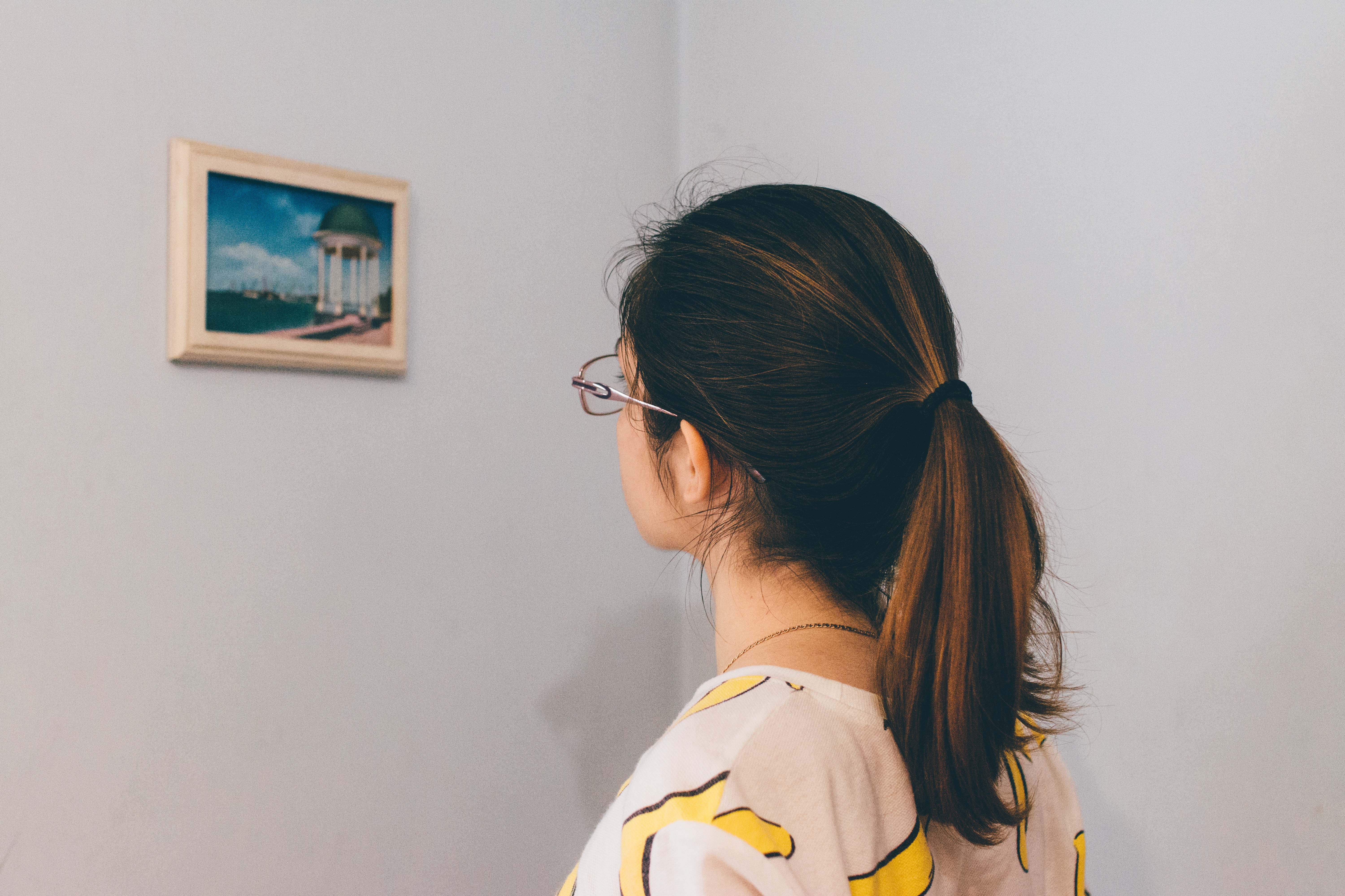 woman looking at blue and green photograph