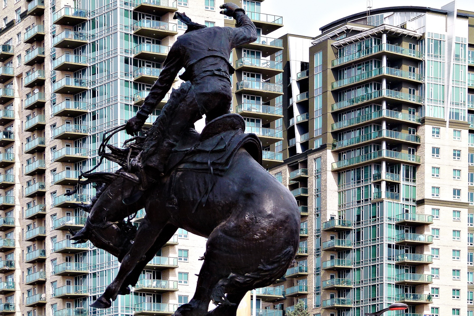 man riding horse black statue