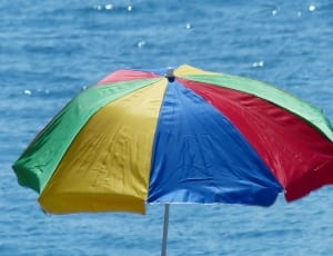 blue red and yellow beach umbrella thumbnail