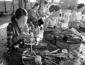 grayscale photo of women making tobacco thumbnail