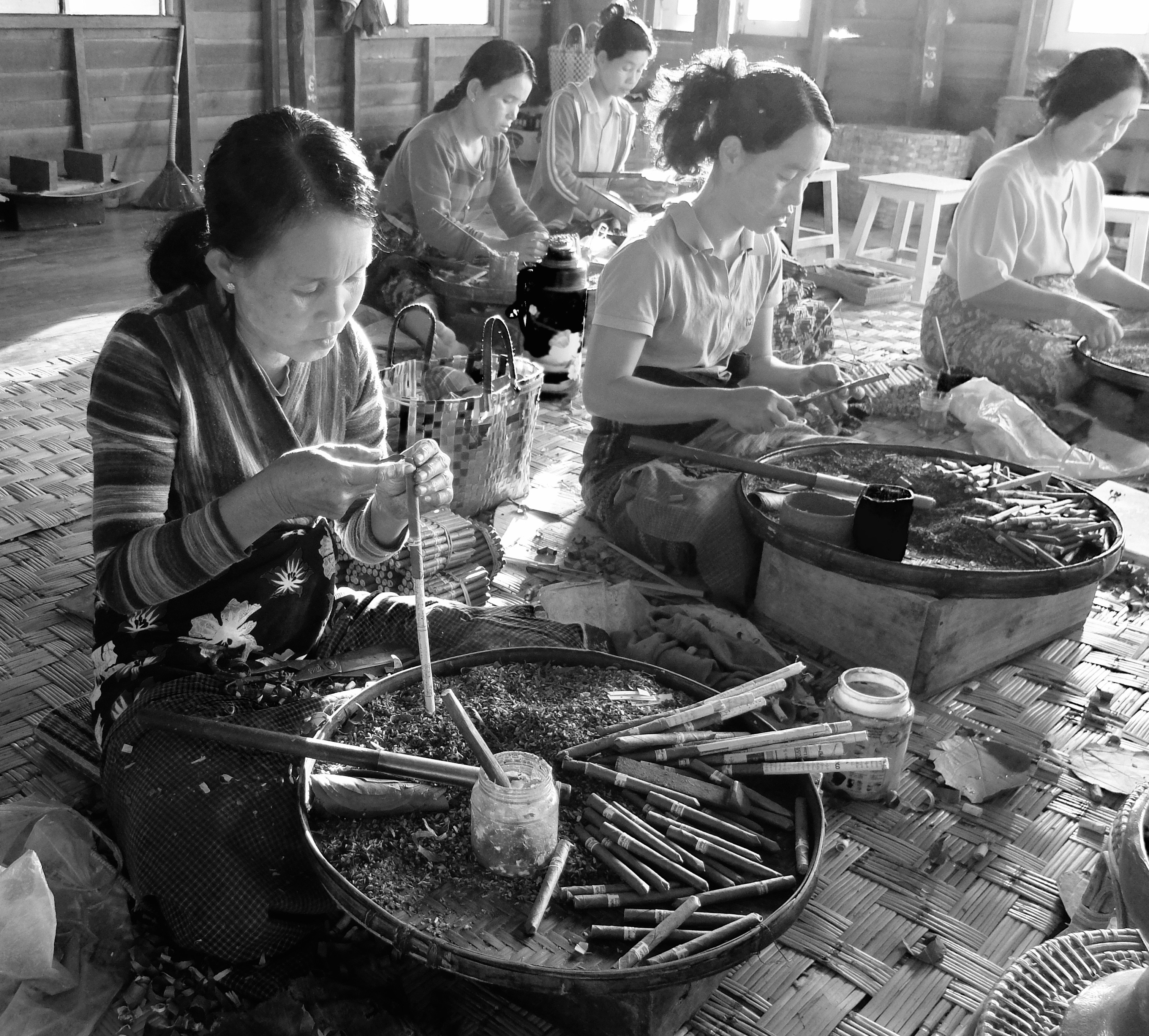 grayscale photo of women making tobacco