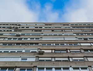 low angle photography of grey and brown high rise building under cloudy sky during  daytime thumbnail