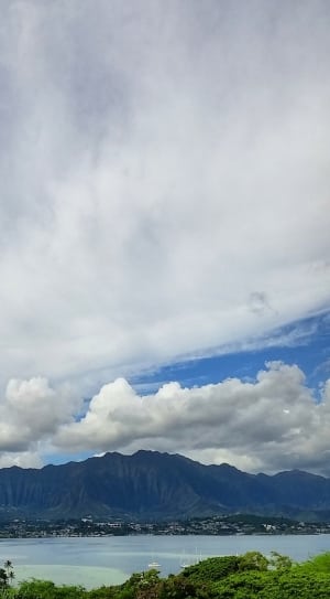 brown mountain under blue sky and white clouds during daytime thumbnail