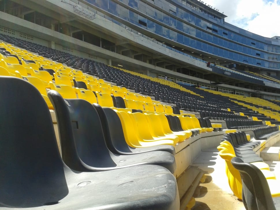 yellow and black plastic stadium chairs preview
