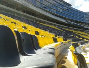 yellow and black plastic stadium chairs thumbnail