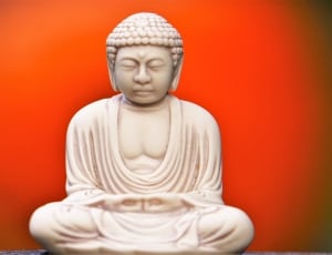 white sitting buddha figurine thumbnail