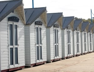 row of white wooden buildings thumbnail