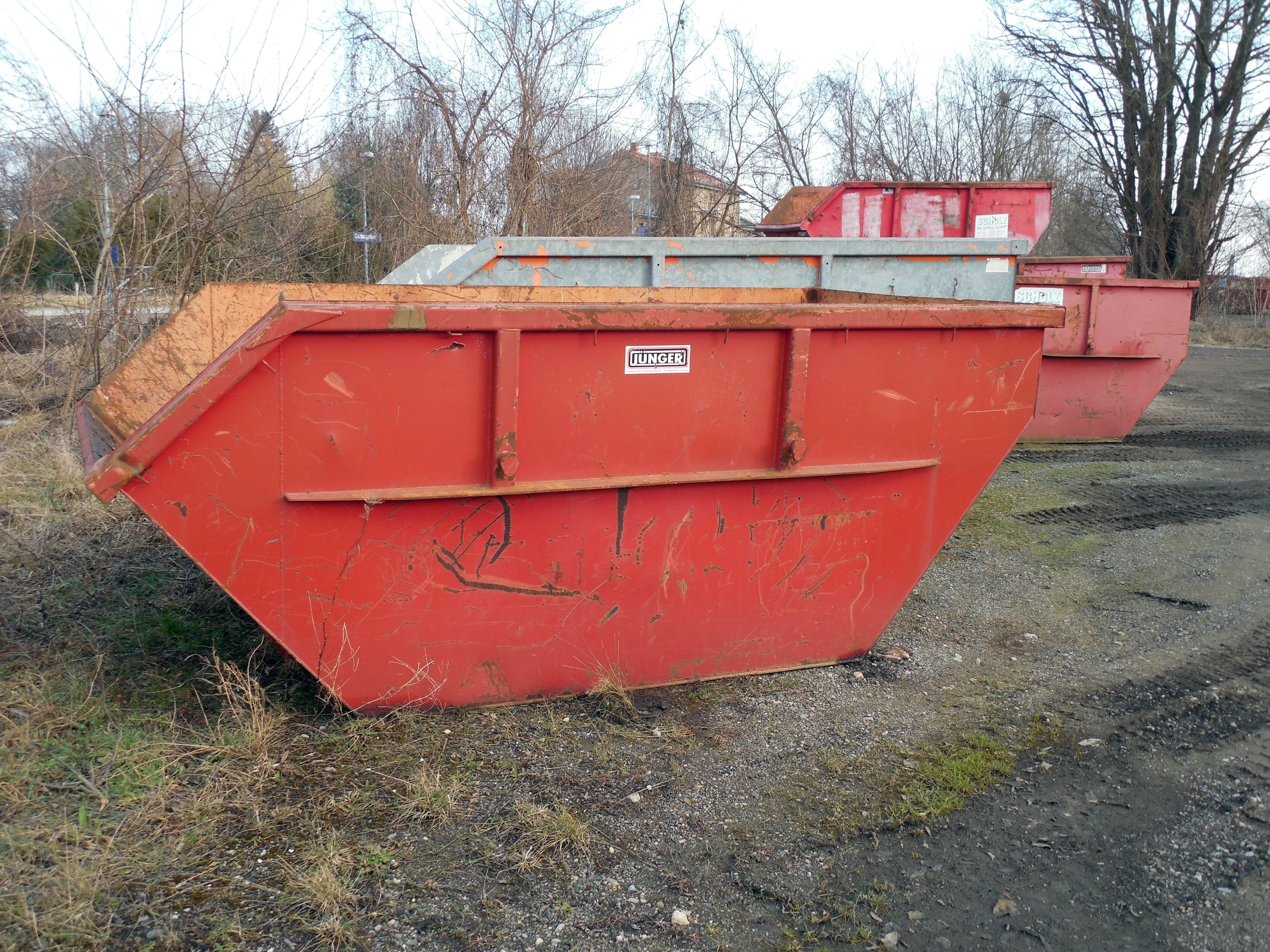 photo of red metal equipment on the ground