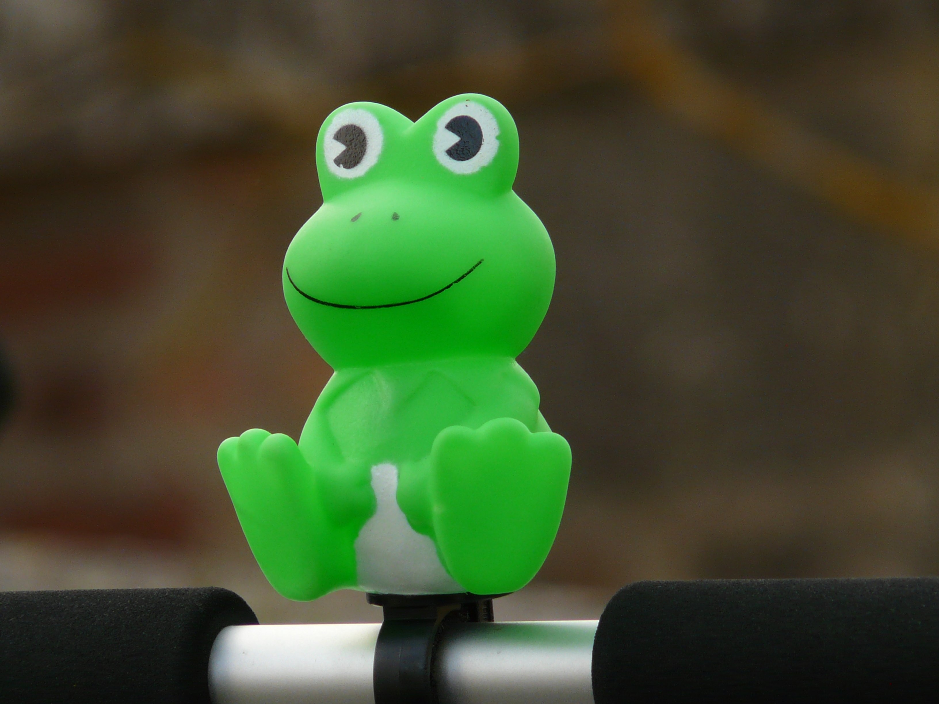 green and white frog plastic toy