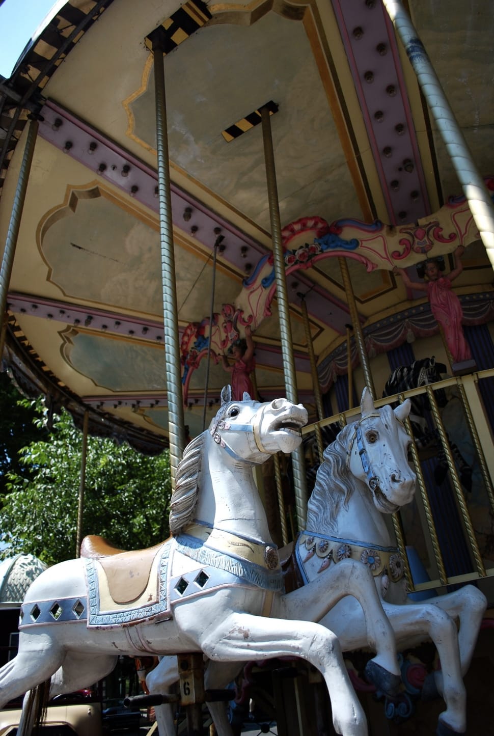 white, brown and blue horse carousel preview