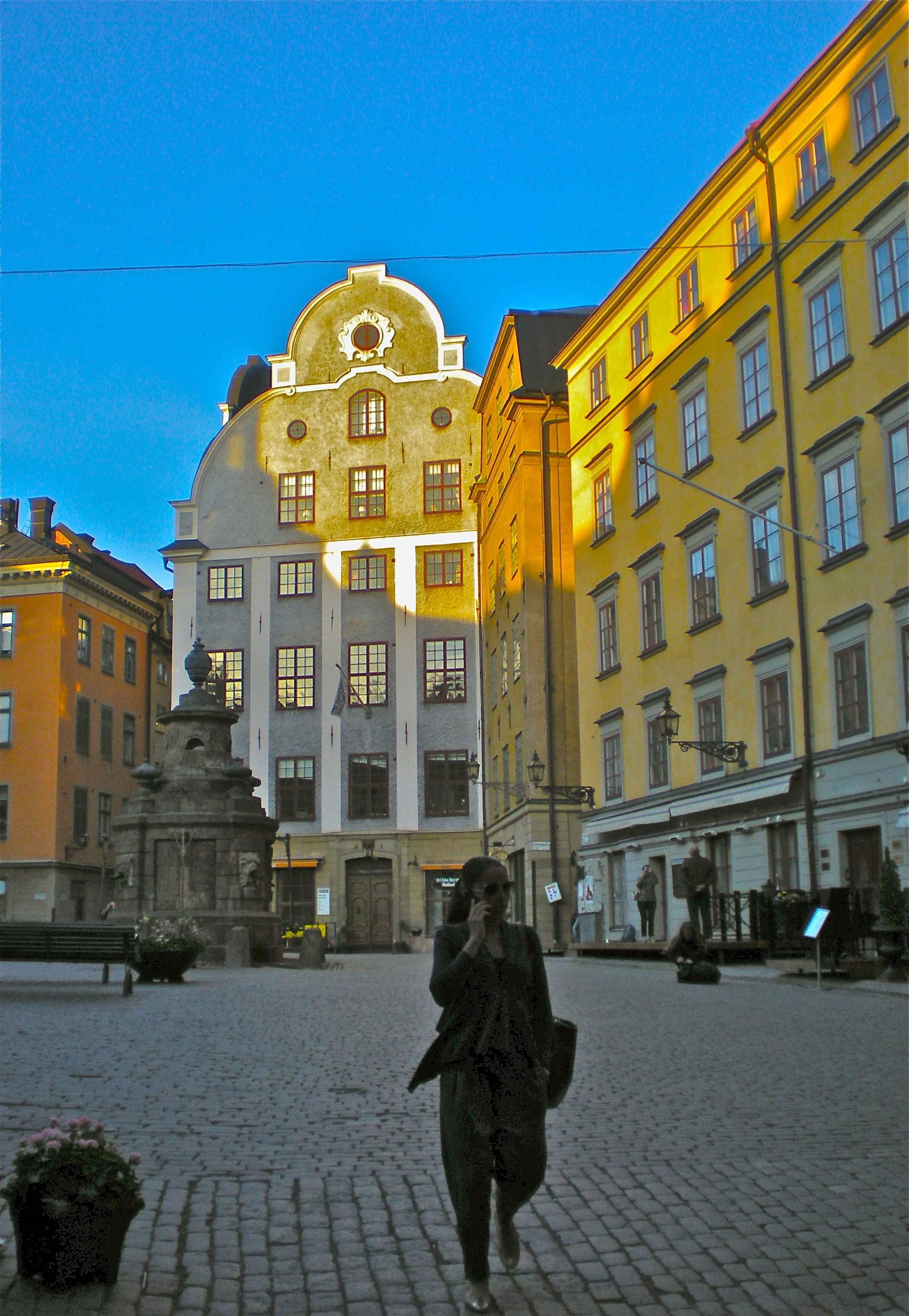 woman walking near white concrete building