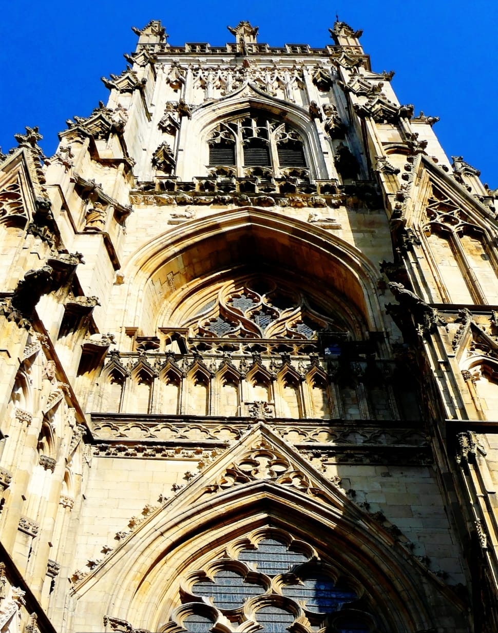 worm's eye view photography of cathedral under clear blue sky during daytime preview