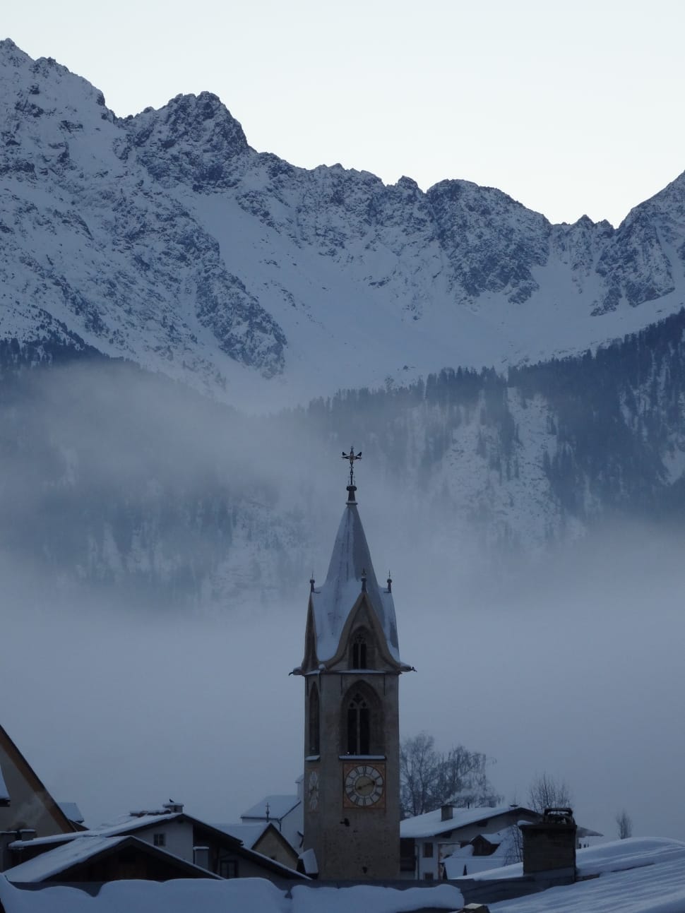 grey concrete church beside snow mountains preview