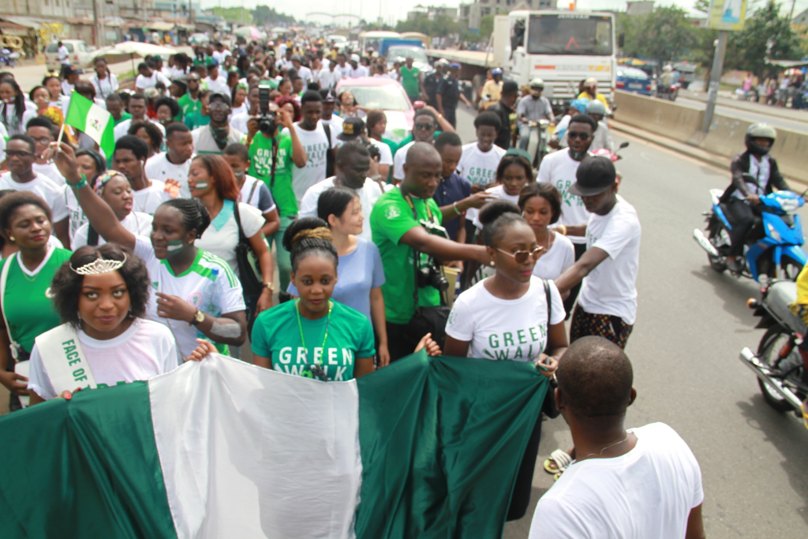 white and green nigeria flag and group of peoples