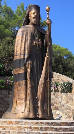 man in brown coat concrete statue thumbnail