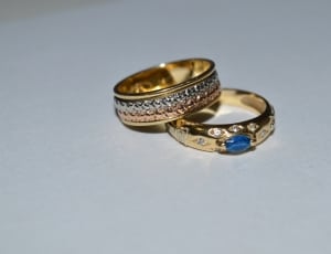 gold band and gold with blue gemstone ring thumbnail