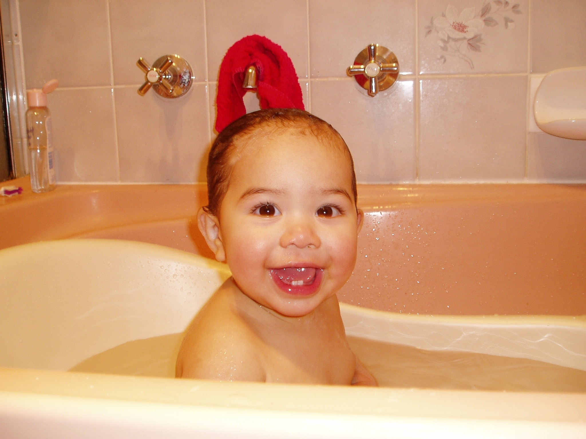 toddler in white bath tub