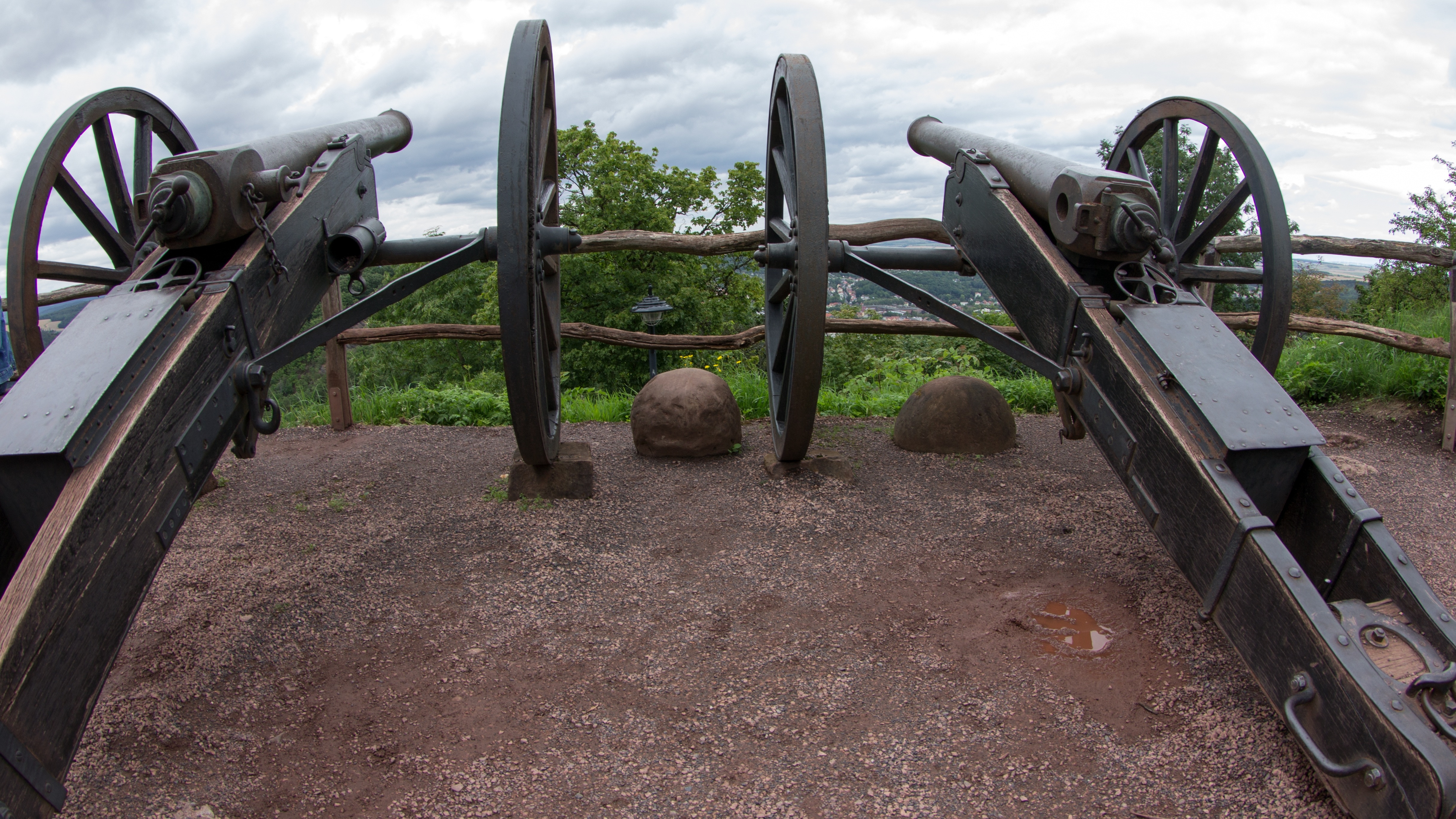 2 black wooden canons