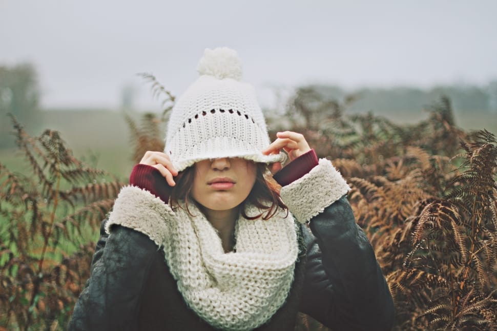 woman wearing white knit cap under cloudy sky preview