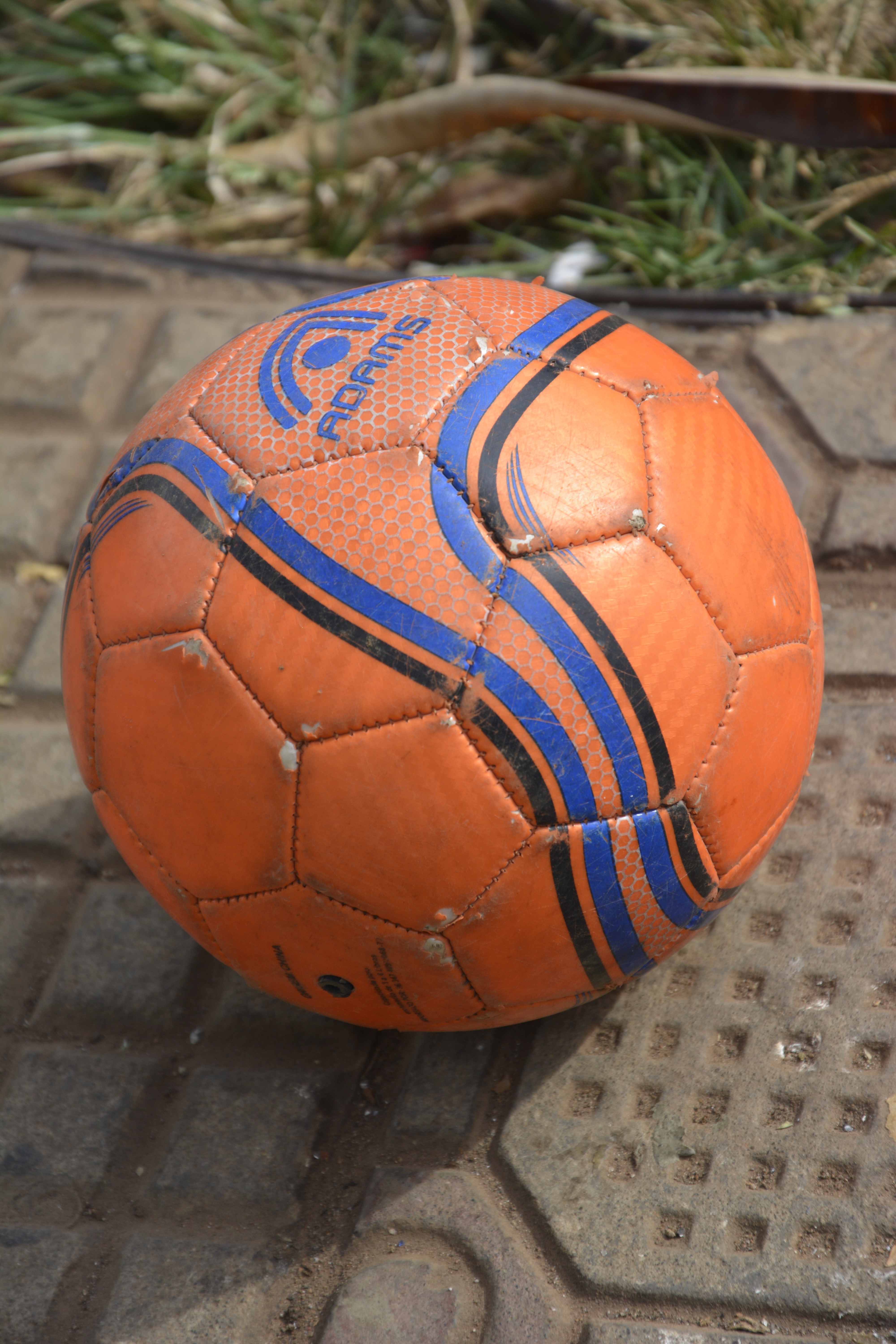 orange and blue adams soccer ball