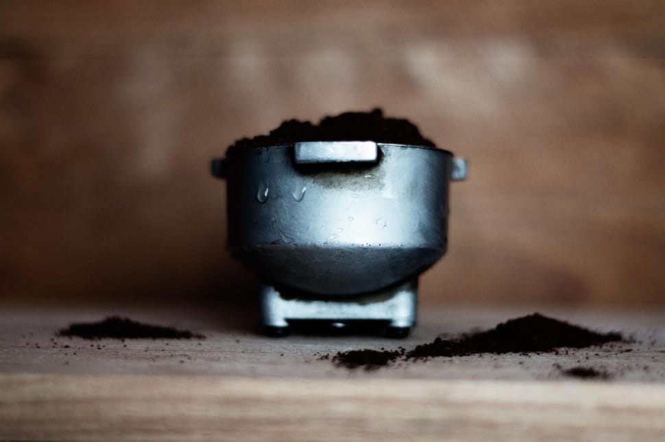 macro shot of gray steel container with black powder preview