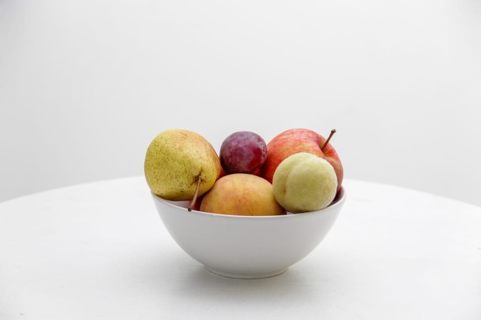 red and green apple with red grape and pear fruit on white ceramic bowl preview