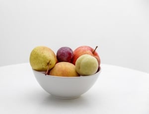 red and green apple with red grape and pear fruit on white ceramic bowl thumbnail