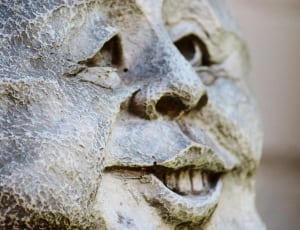 man smiling statue during daytime thumbnail