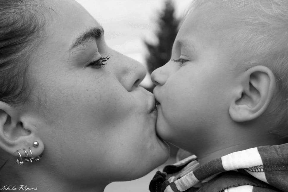 mother kissing child grayscale photo preview