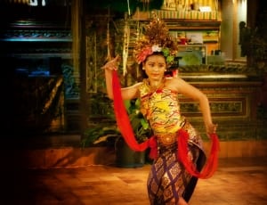 woman dancing while holding red textiles thumbnail