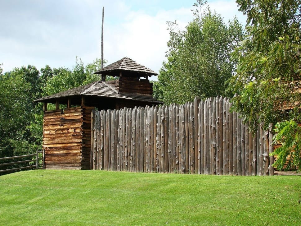 green open field grass ans brown wooden fence preview