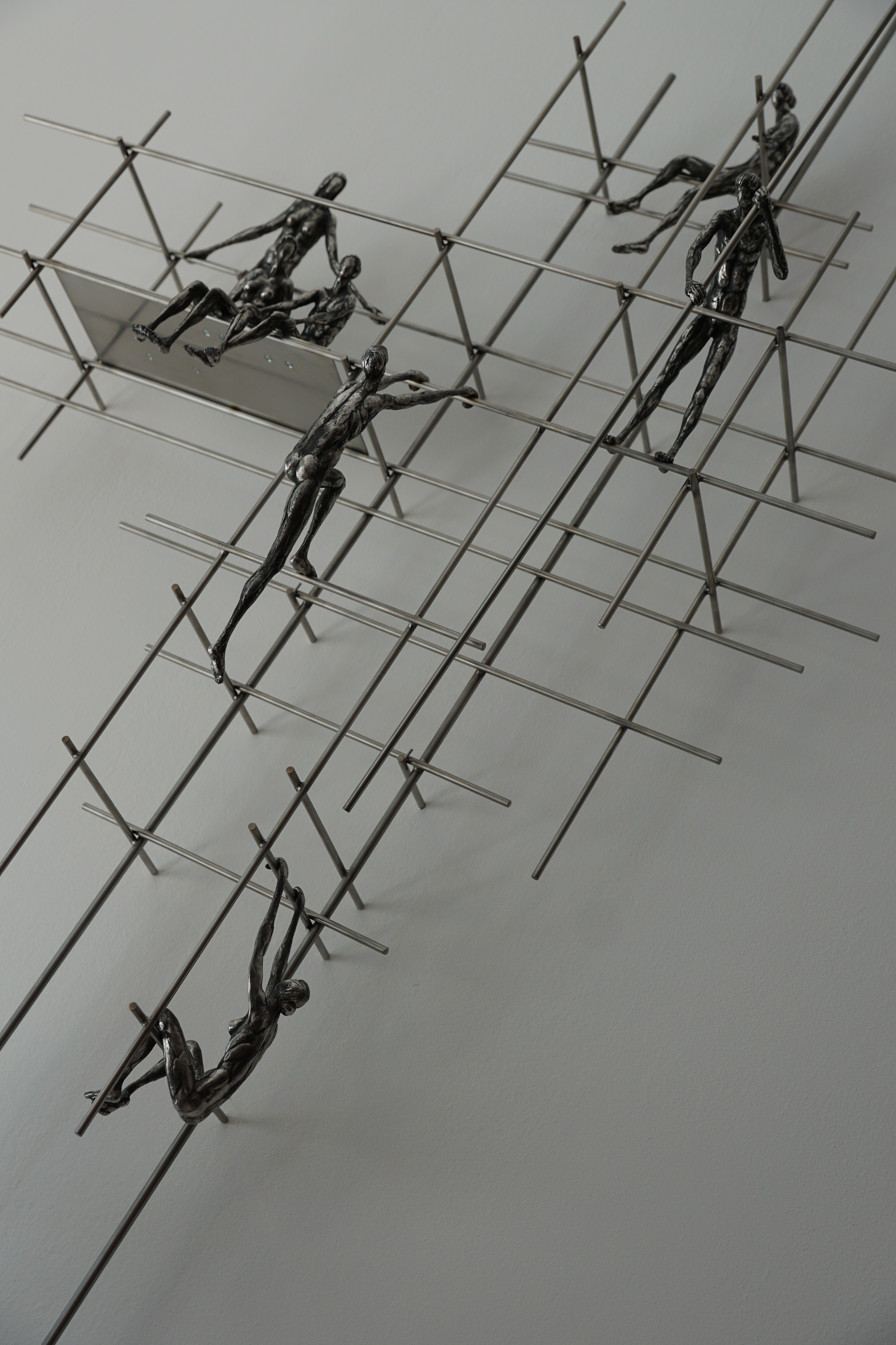 6 person climbing on frame metal figurines