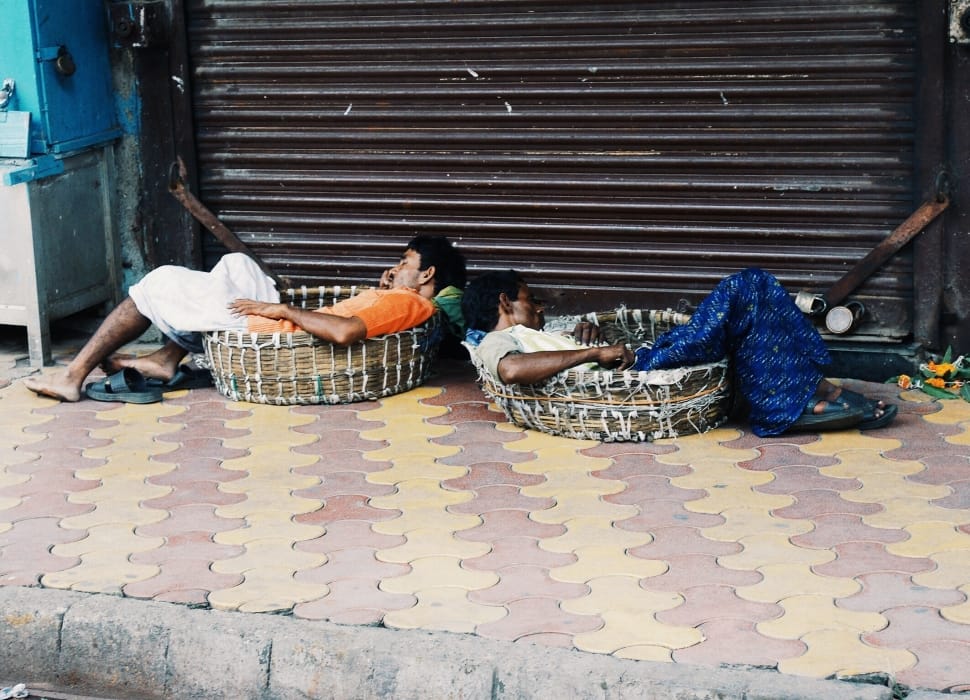 two male laying on round basket preview
