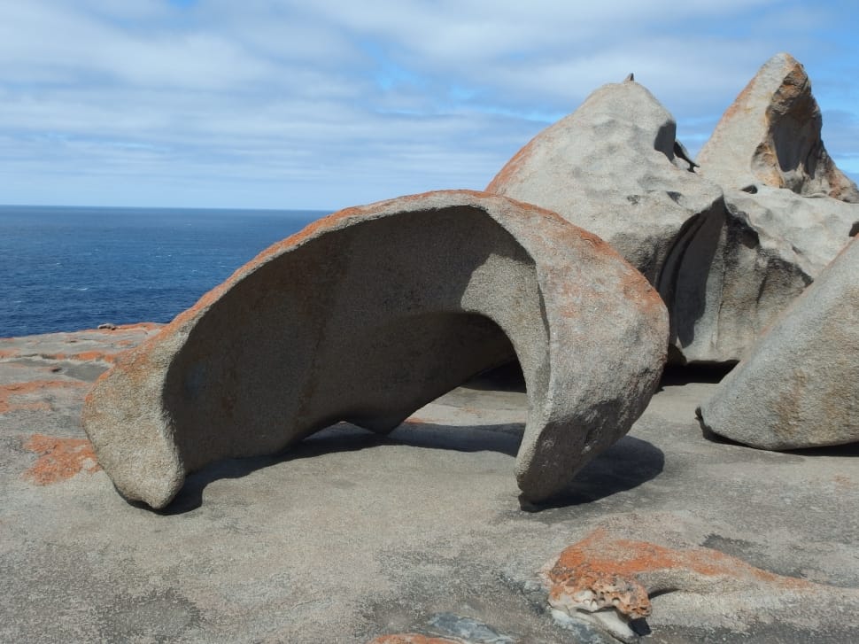 gray stone boulder near ocean preview