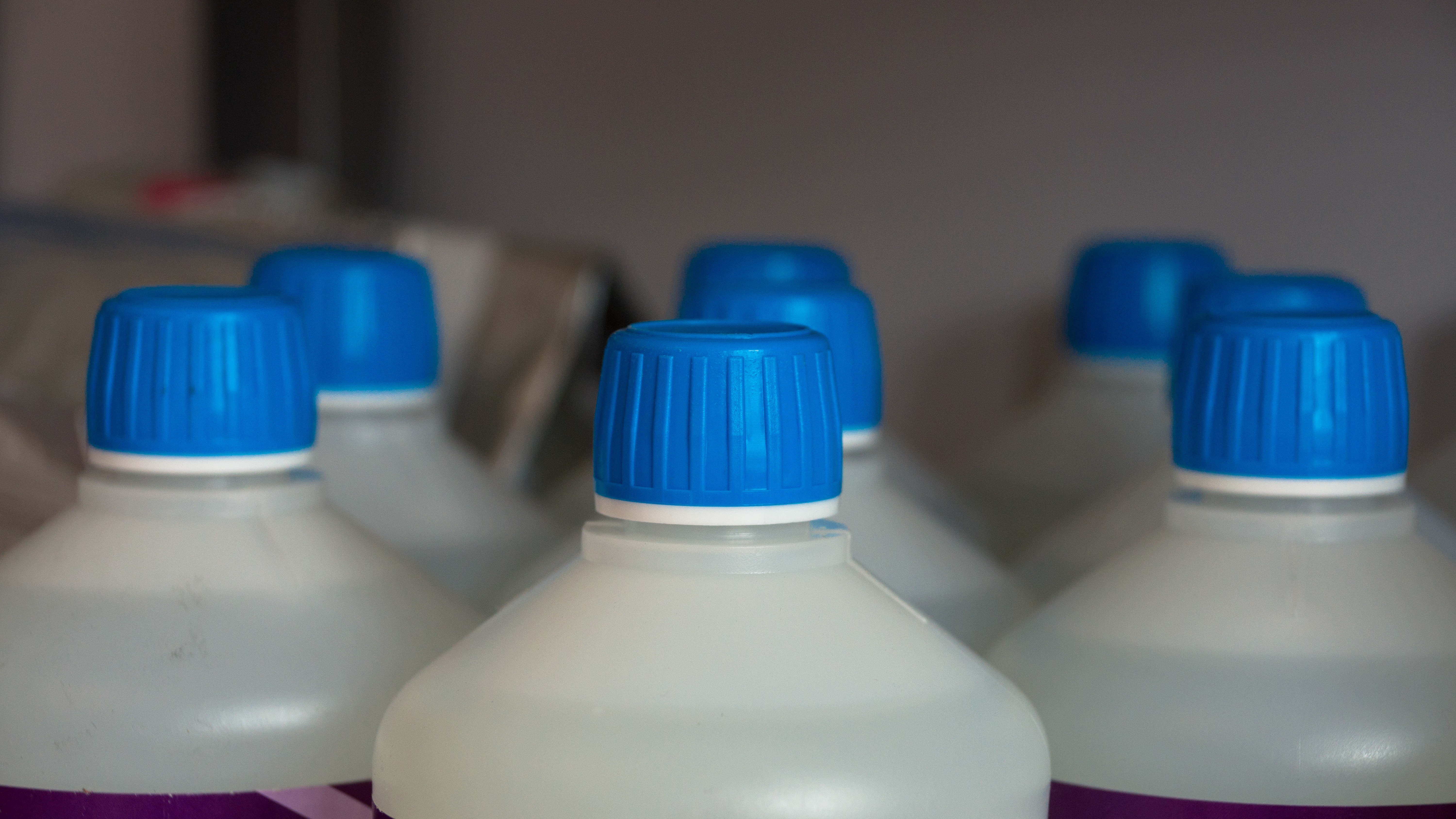 8 white plastic bottles