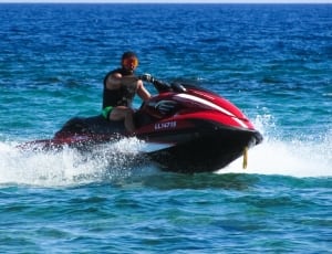 red and black personal water craft thumbnail