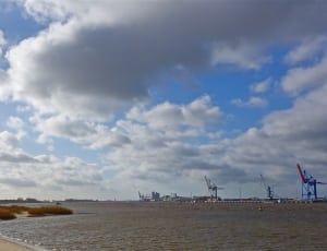 seashore under cloudy sky during daytime thumbnail