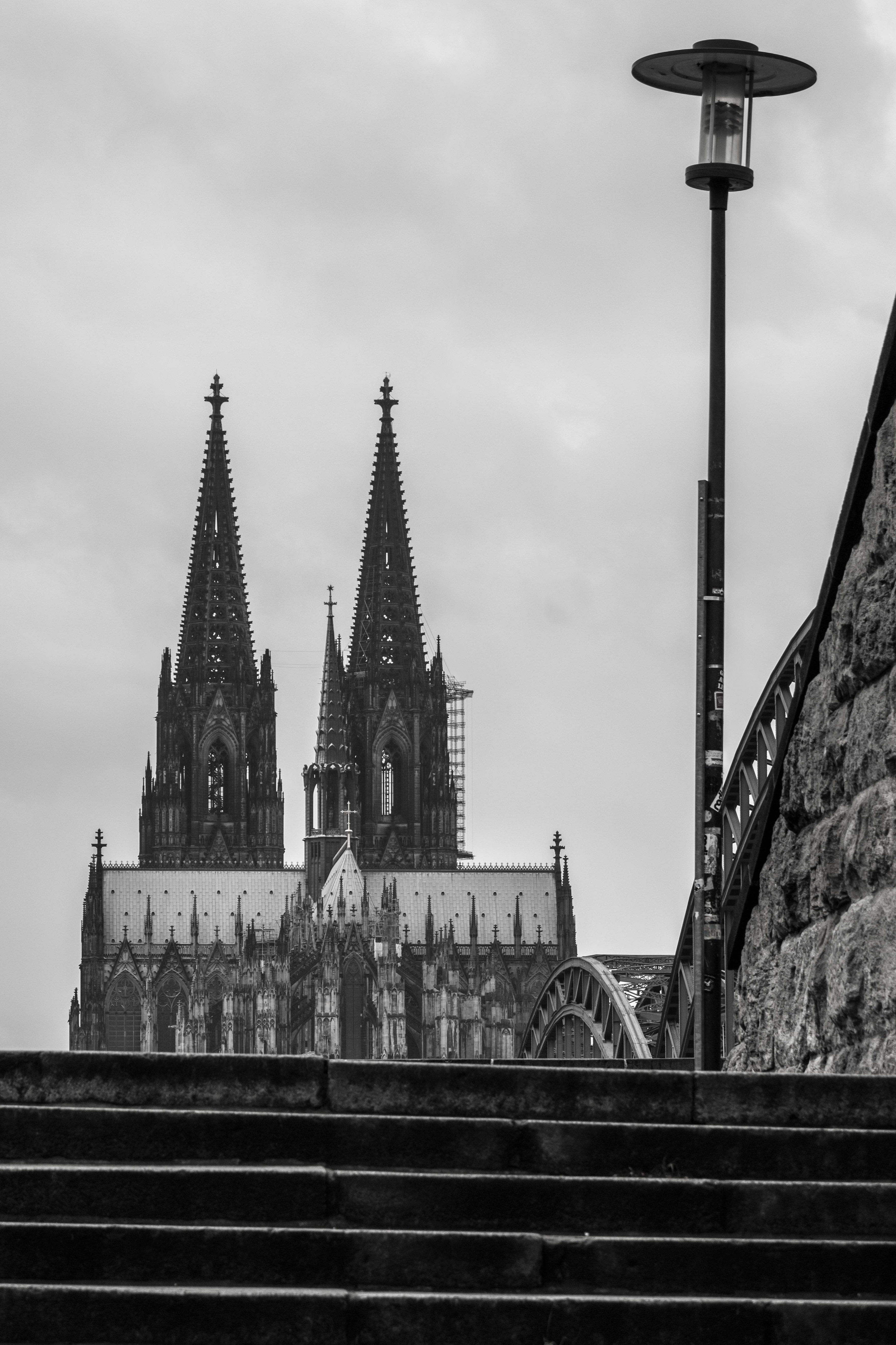 gray-scale photography of building and stairway with tower light