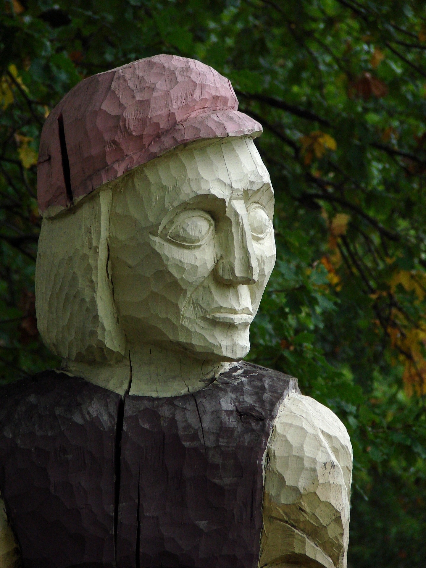 human with pink cap statue