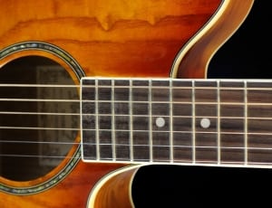 brown 6-string guitar closeup photo thumbnail