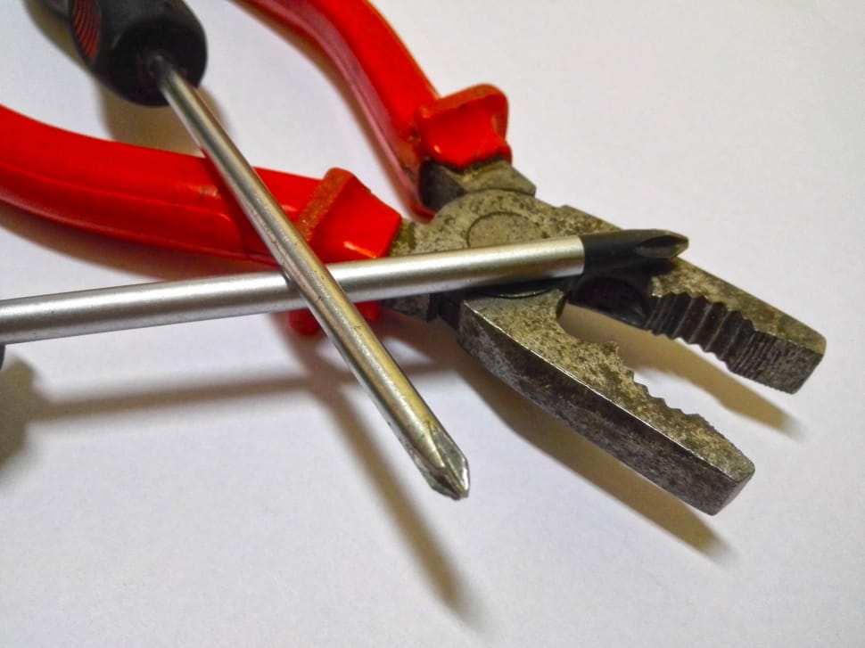 red handled pliers and philips head screw drivers preview