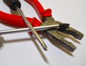 red handled pliers and philips head screw drivers thumbnail