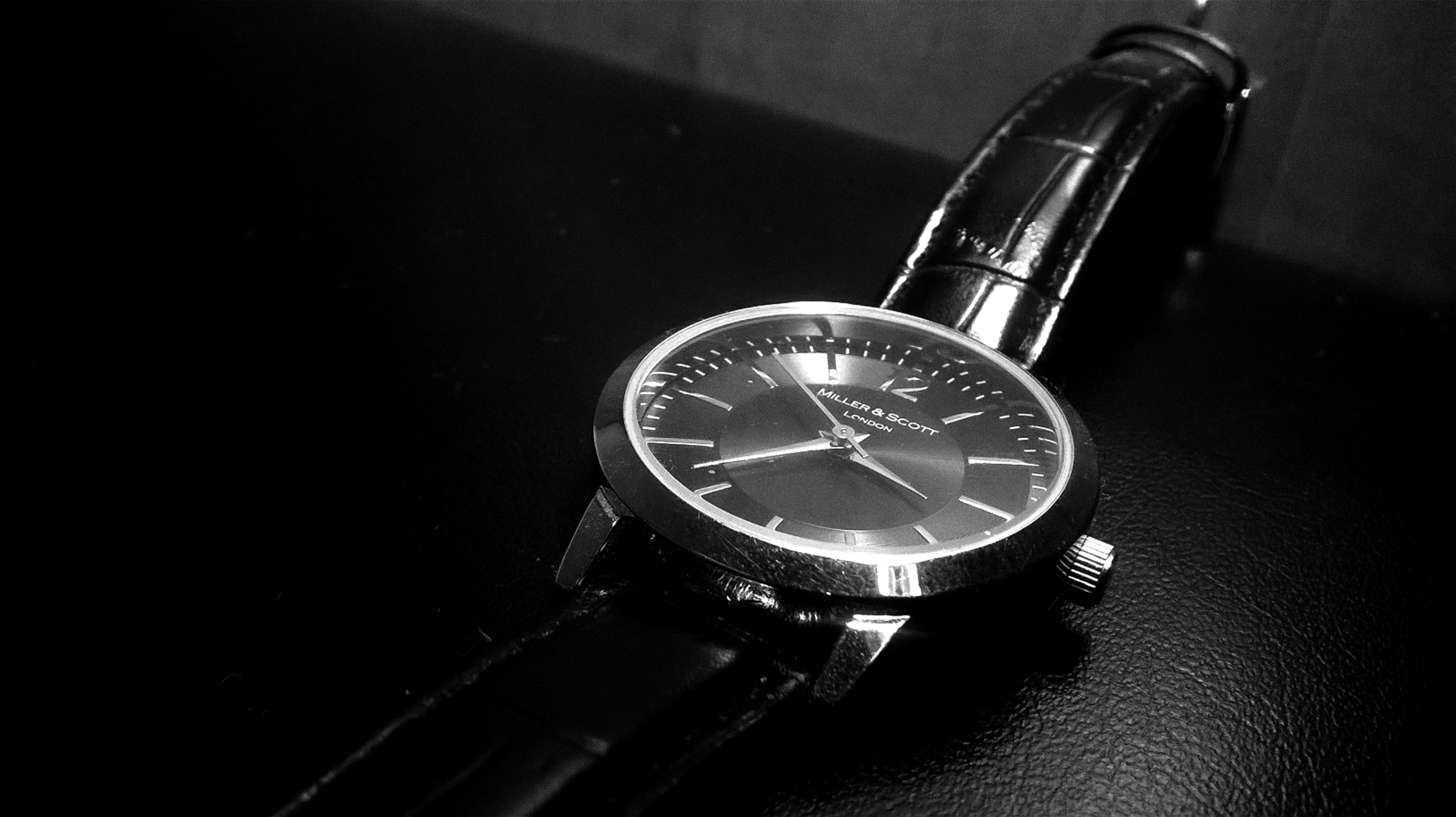 black leather strap round analog watch