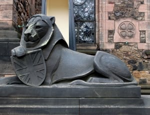 black concrete statue of a lion thumbnail