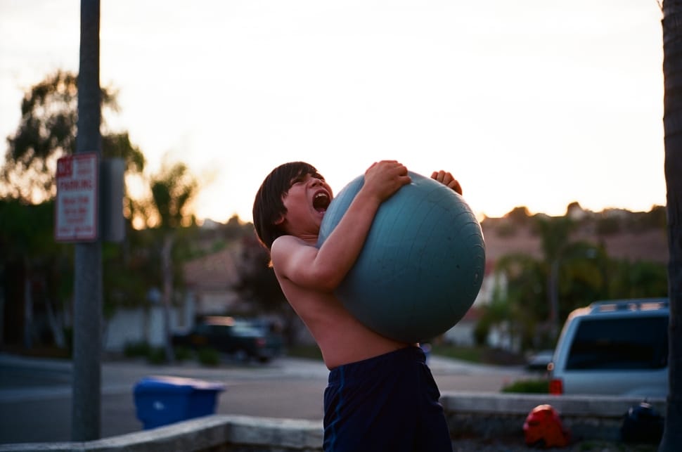 boy hugging tightly to stability ball preview