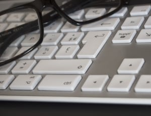 black framed eyeglasses and silver computer keyboard thumbnail